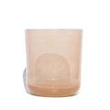 This image shows a cylindrical translucent glass candle container in a warm cream color. 