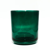 This image shows a cylindrical translucent glass candle container in an emerald green color.