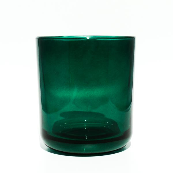 This image shows a cylindrical translucent glass candle container in an emerald green color.