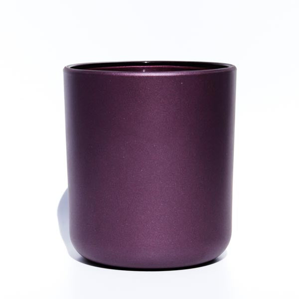 This image shows a cylindrical opaque  glass candle container in a metallic deep purple color.