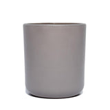 This image shows a cylindrical opaque  glass candle container in a grey color.