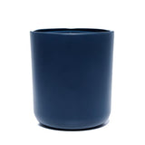 This image shows a cylindrical opaque  glass candle container in a navy blue color.