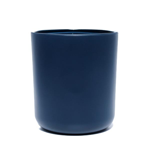 This image shows a cylindrical opaque  glass candle container in a navy blue color.