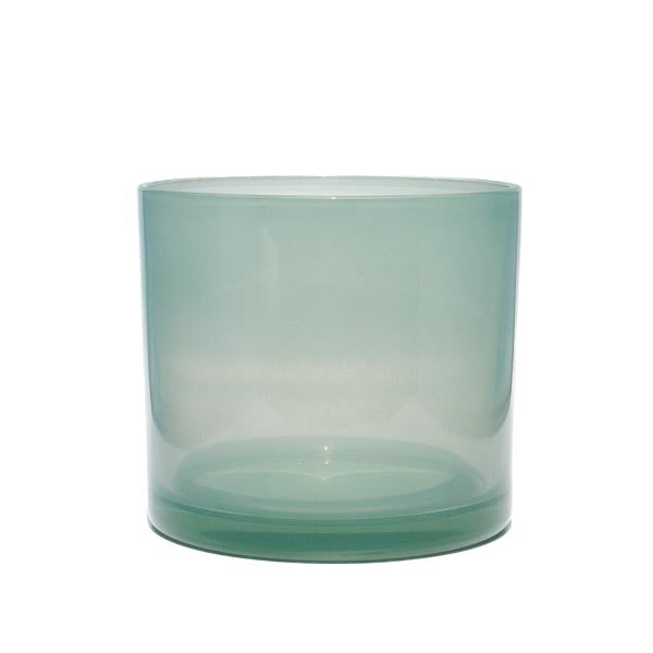 This image shows a cylindrical opaque  glass candle container in a  sea foam color.