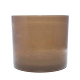 This image shows a cylindrical translucent  glass candle container in a  mushroom brown color.