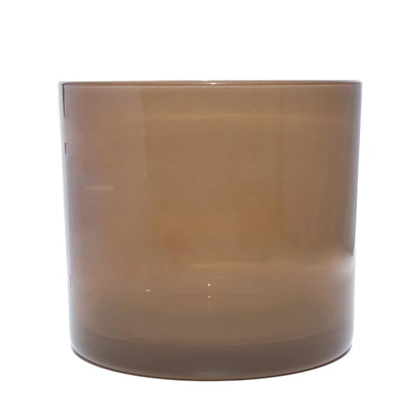 This image shows a cylindrical translucent  glass candle container in a  mushroom brown color.